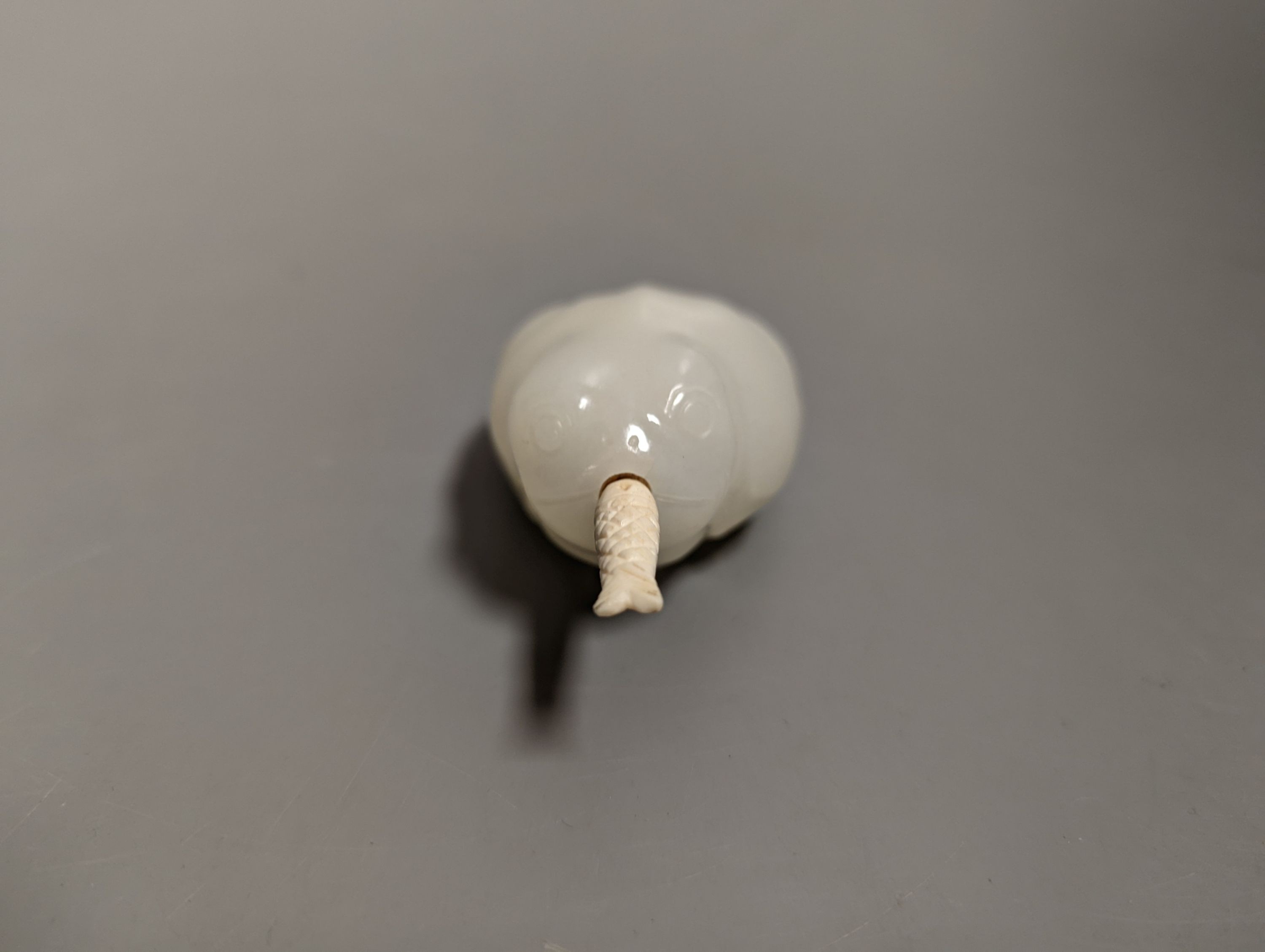 A Chinese white jade 'toad' snuff bottle, the stone of excellent even tone, 8cms long, including stopper